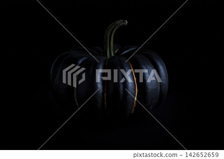 Halloween pumpkin glowing softly on a dark background for a spooky atmosphere Halloween pumpkin glowing softly on a dark background for a spooky atmosphere 142652659