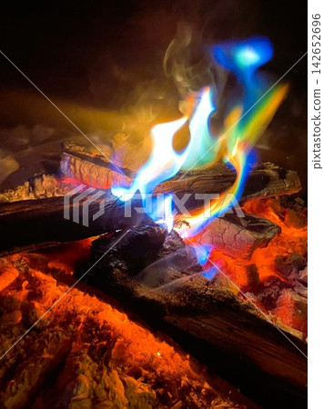 The vibrant flames flickering in the campfire. The vibrant flames flickering in the campfire. 142652696