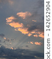 Dramatic sunset clouds and a gradient of golden light 142652904