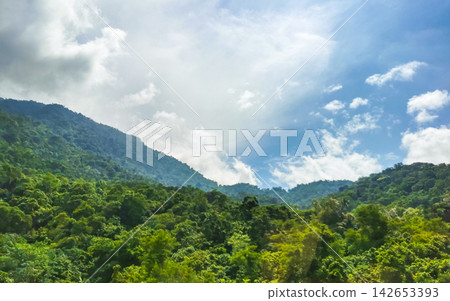 Tropical mountain jungle forest trees clouds and blue sky Brazil. Tropical mountain jungle forest trees clouds and blue sky Brazil. 142653393