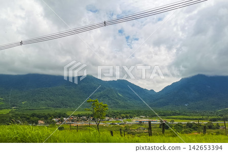 Tropical mountain jungle forest trees clouds and dark sky Brazil. Tropical mountain jungle forest trees clouds and dark sky Brazil. 142653394