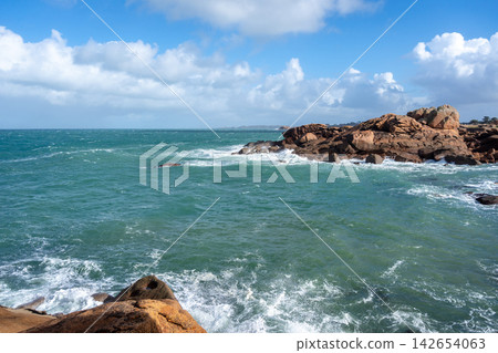Mean Ruz coastline waves hitting granite rocks in Tregastel, Brittany, France Mean Ruz coastline waves hitting granite rocks in Tregastel, Brittany, France 142654063
