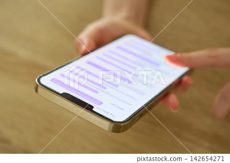The hands of a young woman sending a message The hands of a young woman sending a message 142654271