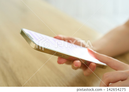 The hands of a young woman sending a message The hands of a young woman sending a message 142654275
