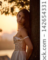 Slavic Woman in Lace Dress by Tree 142654331