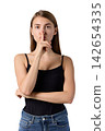 Slavic woman making quiet gesture in studio portrait 142654335