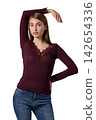 Slavic woman in burgundy lace top and jeans 142654336