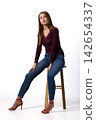 Slavic fashion model seated in studio portrait 142654337