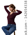 Slavic fashion model seated in studio portrait 142654338
