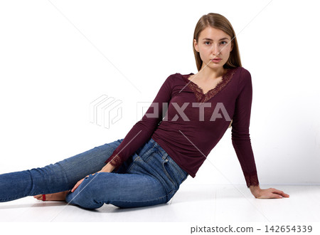 Slavic woman in lace top posing on floor Slavic woman in lace top posing on floor 142654339