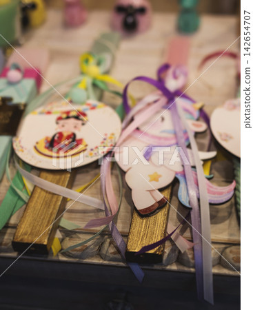 Greek Easter candles, assortment selection of handmade crafted traditional lambada, multicoloured wax candles with ribbon for sale in local store market, Orthodox Easter traditions in Athens, Greece 142654707