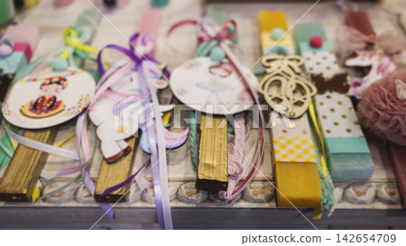 Greek Easter candles, assortment selection of handmade crafted traditional lambada, multicoloured wax candles with ribbon for sale in local store market, Orthodox Easter traditions in Athens, Greece Greek Easter candles, assortment selection of handmade crafted traditional lambada, multicoloured wax candles with ribbon for sale in local store market, Orthodox Easter traditions in Athens, Greece 142654709