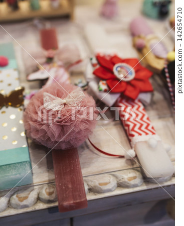 Greek Easter candles, assortment selection of handmade crafted traditional lambada, multicoloured wax candles with ribbon for sale in local store market, Orthodox Easter traditions in Athens, Greece Greek Easter candles, assortment selection of handmade crafted traditional lambada, multicoloured wax candles with ribbon for sale in local store market, Orthodox Easter traditions in Athens, Greece 142654710