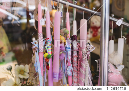 Greek Easter candles, assortment selection of handmade crafted traditional lambada, multicoloured wax candles with ribbon for sale in local store market, Orthodox Easter traditions in Athens, Greece Greek Easter candles, assortment selection of handmade crafted traditional lambada, multicoloured wax candles with ribbon for sale in local store market, Orthodox Easter traditions in Athens, Greece 142654716