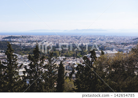 Athens, Attica, Greece, beautiful panoramic view of Athens cityscape, with The Parthenon, mountains, sea and scenery beyond the city, seen from Mount Lycabettus Hill observation deck in a sunny day Athens, Attica, Greece, beautiful panoramic view of Athens cityscape, with The Parthenon, mountains, sea and scenery beyond the city, seen from Mount Lycabettus Hill observation deck in a sunny day 142654785