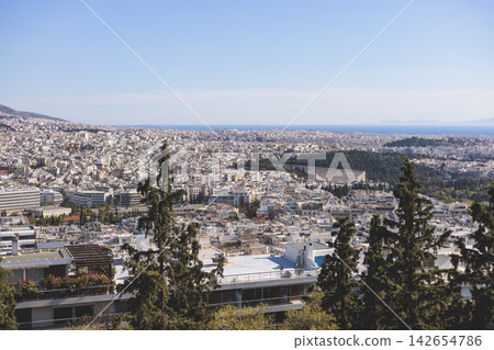 Athens, Attica, Greece, beautiful panoramic view of Athens cityscape, with The Parthenon, mountains, sea and scenery beyond the city, seen from Mount Lycabettus Hill observation deck in a sunny day Athens, Attica, Greece, beautiful panoramic view of Athens cityscape, with The Parthenon, mountains, sea and scenery beyond the city, seen from Mount Lycabettus Hill observation deck in a sunny day 142654786