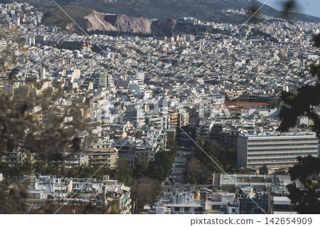Athens, Attica, Greece, beautiful panoramic view of Athens cityscape, with The Parthenon, mountains, sea and scenery beyond the city, seen from Mount Lycabettus Hill observation deck in a sunny day Athens, Attica, Greece, beautiful panoramic view of Athens cityscape, with The Parthenon, mountains, sea and scenery beyond the city, seen from Mount Lycabettus Hill observation deck in a sunny day 142654909
