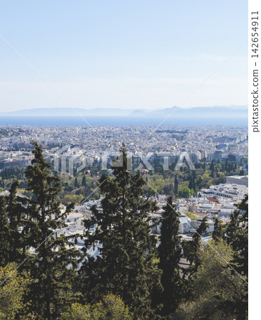 Athens, Attica, Greece, beautiful panoramic view of Athens cityscape, with The Parthenon, mountains, sea and scenery beyond the city, seen from Mount Lycabettus Hill observation deck in a sunny day Athens, Attica, Greece, beautiful panoramic view of Athens cityscape, with The Parthenon, mountains, sea and scenery beyond the city, seen from Mount Lycabettus Hill observation deck in a sunny day 142654911