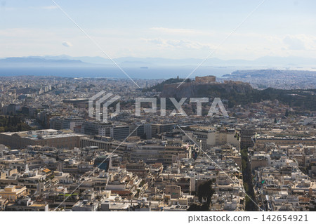 Athens, Attica, Greece, beautiful panoramic view of Athens cityscape, with The Parthenon, mountains, sea and scenery beyond the city, seen from Mount Lycabettus Hill observation deck in a sunny day Athens, Attica, Greece, beautiful panoramic view of Athens cityscape, with The Parthenon, mountains, sea and scenery beyond the city, seen from Mount Lycabettus Hill observation deck in a sunny day 142654921