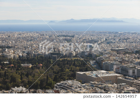 Athens, Attica, Greece, beautiful panoramic view of Athens cityscape, with The Parthenon, mountains, sea and scenery beyond the city, seen from Mount Lycabettus Hill observation deck in a sunny day Athens, Attica, Greece, beautiful panoramic view of Athens cityscape, with The Parthenon, mountains, sea and scenery beyond the city, seen from Mount Lycabettus Hill observation deck in a sunny day 142654957