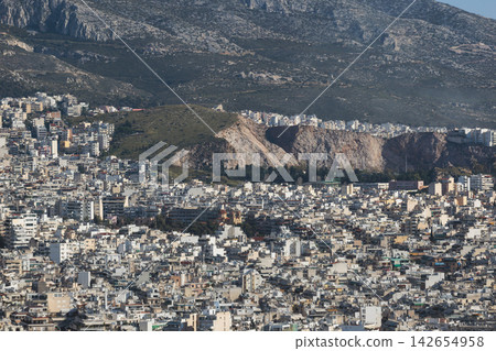 Athens, Attica, Greece, beautiful panoramic view of Athens cityscape, with The Parthenon, mountains, sea and scenery beyond the city, seen from Mount Lycabettus Hill observation deck in a sunny day Athens, Attica, Greece, beautiful panoramic view of Athens cityscape, with The Parthenon, mountains, sea and scenery beyond the city, seen from Mount Lycabettus Hill observation deck in a sunny day 142654958