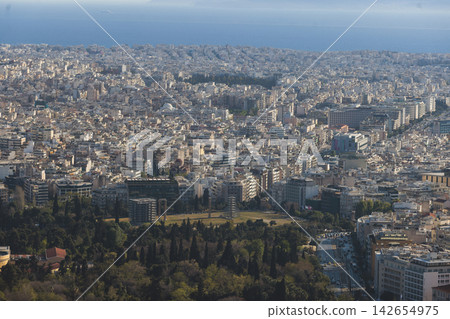 Athens, Attica, Greece, beautiful panoramic view of Athens cityscape, with The Parthenon, mountains, sea and scenery beyond the city, seen from Mount Lycabettus Hill observation deck in a sunny day Athens, Attica, Greece, beautiful panoramic view of Athens cityscape, with The Parthenon, mountains, sea and scenery beyond the city, seen from Mount Lycabettus Hill observation deck in a sunny day 142654975