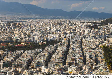 Athens, Attica, Greece, beautiful panoramic view of Athens cityscape, with The Parthenon, mountains, sea and scenery beyond the city, seen from Mount Lycabettus Hill observation deck in a sunny day Athens, Attica, Greece, beautiful panoramic view of Athens cityscape, with The Parthenon, mountains, sea and scenery beyond the city, seen from Mount Lycabettus Hill observation deck in a sunny day 142654977