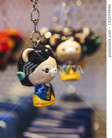 Tourist gifts and Korean souvenirs from South Korea, toys and figurines, fridge magnets and key ring keychain, key fobs and postcards with symbols of South Korea in a local gift vendor shop market Tourist gifts and Korean souvenirs from South Korea, toys and figurines, fridge magnets and key ring keychain, key fobs and postcards with symbols of South Korea in a local gift vendor shop market 142654999