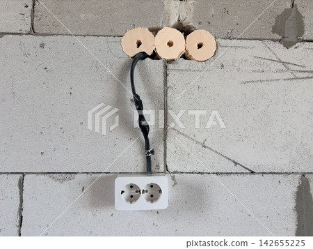 Electrical wiring in a new building, a temporary outlet in an unfinished wall Electrical wiring in a new building, a temporary outlet in an unfinished wall 142655225