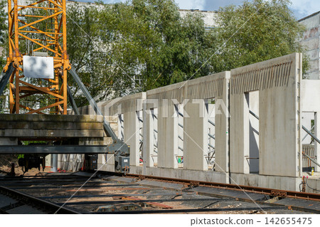 Precast Concrete Wall Panels Installed at Active Urban Building Construction Site with Tower Crane Precast Concrete Wall Panels Installed at Active Urban Building Construction Site with Tower Crane 142655475