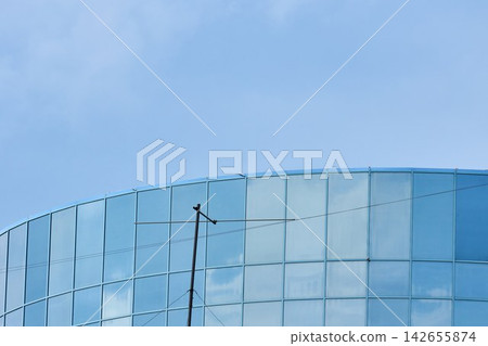 Curved Glass Architecture Facade with Sky Reflections Curved Glass Architecture Facade with Sky Reflections 142655874