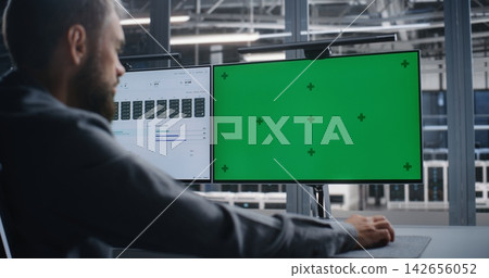 IT Engineer Reviewing Customizable Monitor During Technical System Diagnostics IT Engineer Reviewing Customizable Monitor During Technical System Diagnostics 142656052
