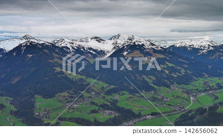 Aerial view of alpine valley with mountains and clouds Aerial view of alpine valley with mountains and clouds 142656062