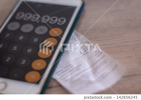 Expense bills and income records used for budgeting financial planning and cost management tasks. Expense bills and income records used for budgeting financial planning and cost management tasks. 142656245