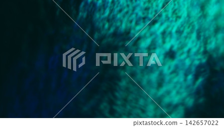 Defocused bright light. Blue color flash. Blur texture glisten luminous visual glimmer flare on abstract bokeh art dark black background. Defocused bright light. Blue color flash. Blur texture glisten luminous visual glimmer flare on abstract bokeh art dark black background. 142657022