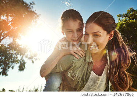 Mother, girl and outdoor for piggy back with happiness, bonding on vacation in Australia. Female person, child and smile for learning or development in nature, cheerful in countryside with sunshine Mother, girl and outdoor for piggy back with happiness, bonding on vacation in Australia. Female person, child and smile for learning or development in nature, cheerful in countryside with sunshine 142657866
