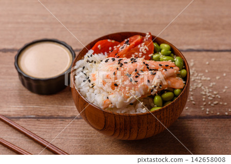 An Asian style bowl with shrimp, edamame, tomatoes, and wakame. A shrimp and vegetable bowl An Asian style bowl with shrimp, edamame, tomatoes, and wakame. A shrimp and vegetable bowl 142658008