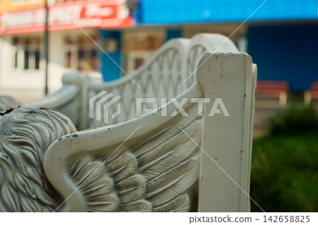 Carved Wing Feather Detail on Ornamental Park Bench Carved Wing Feather Detail on Ornamental Park Bench 142658825
