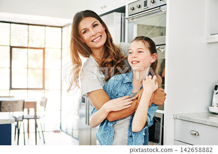 Woman, kid and love with hug in house for connection, support and bonding together on weekend. Family, thinking and girl with mom in embrace for parenting, happiness and care of daughter in kitchen Woman, kid and love with hug in house for connection, support and bonding together on weekend. Family, thinking and girl with mom in embrace for parenting, happiness and care of daughter in kitchen 142658882