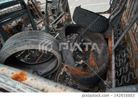 Burned Wheel and Melted Exploded Rubber Tire inside Van Shell Burned Wheel and Melted Exploded Rubber Tire inside Van Shell 142658883
