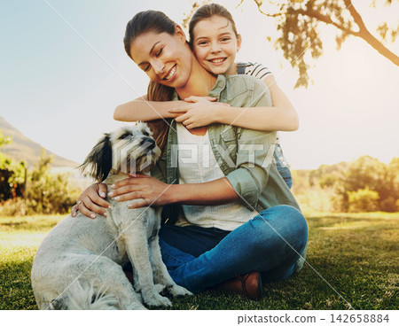Mother, girl and playing with dog in park for bonding, relax and happy with fun activity in nature. Family, woman and daughter with puppy on grass in environment with sunlight, portrait and smile Mother, girl and playing with dog in park for bonding, relax and happy with fun activity in nature. Family, woman and daughter with puppy on grass in environment with sunlight, portrait and smile 142658884