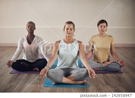 Women, instructor and lotus with peace for meditation in yoga for holistic wellness, mental health or healing in class. Group, relax or posture on mat for stress relief, zen and calm with eyes closed 142658947