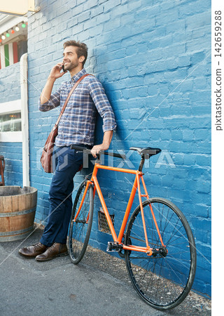 Bike, phone call and smile with business man on blue wall in city for morning commute to work. Contact, thinking and transportation with happy young employee talking on mobile for communication Bike, phone call and smile with business man on blue wall in city for morning commute to work. Contact, thinking and transportation with happy young employee talking on mobile for communication 142659288