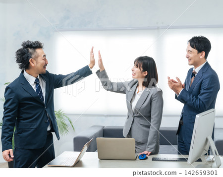 Group of business people high-fiving in the office Group of business people high-fiving in the office 142659301