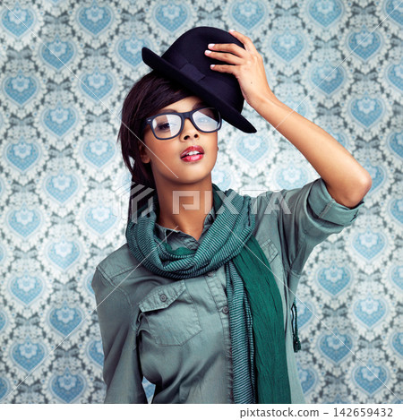Woman, fashion and portrait in studio with wallpaper for trendy or funky clothing or cool hat. Confident, female person and glasses for vision with bold makeup for beauty by pattern background Woman, fashion and portrait in studio with wallpaper for trendy or funky clothing or cool hat. Confident, female person and glasses for vision with bold makeup for beauty by pattern background 142659432