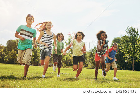 Happy kids, playing and running with grass field in nature for fun, playful day or sunshine at park. Diversity or group of excited children or youth enjoying sunny outdoor holiday or weekend together Happy kids, playing and running with grass field in nature for fun, playful day or sunshine at park. Diversity or group of excited children or youth enjoying sunny outdoor holiday or weekend together 142659435