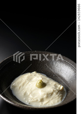 Fresh yuba (tofu skin) photographed alone against a black background. Fresh yuba (tofu skin) photographed alone against a black background. 142659666