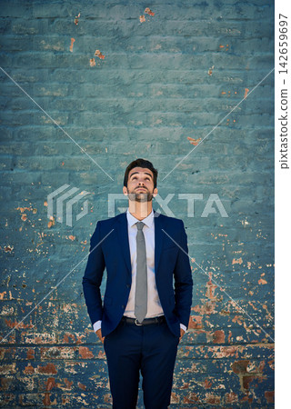 Businessman, fashion and thinking with ambition on wall for job or career opportunity on mockup space. Man or employee looking up in wonder or thought for business decision on an urban background Businessman, fashion and thinking with ambition on wall for job or career opportunity on mockup space. Man or employee looking up in wonder or thought for business decision on an urban background 142659697