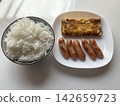 White rice, scrambled eggs, and sausages 142659723