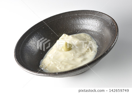 Fresh yuba (tofu skin) photographed alone against a white background. Fresh yuba (tofu skin) photographed alone against a white background. 142659749